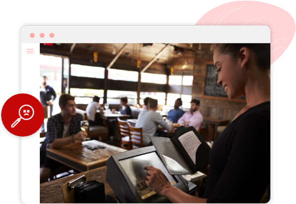 A happy waitress in a busy restaurant using Foodhub’s EPOS to send orders direct to the kitchen which displays on Kitchen Display